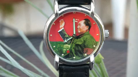 Wrist watch with Chairman Mao waving his hand at the masses.
