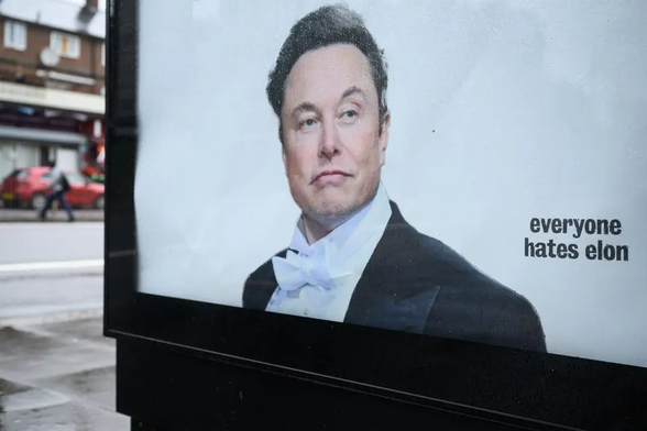 A samizdat poster installed in a bus shelter with a photo of an imperious Elon Musk wearing a tux and the text "everyone hates elon"