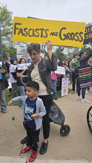 A mother and child with a Fascists are Gross sign. 