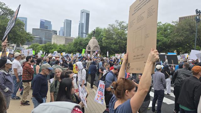 A massive crowd of thousands in the grounds of the Texas Capitol in downtown Austin. 