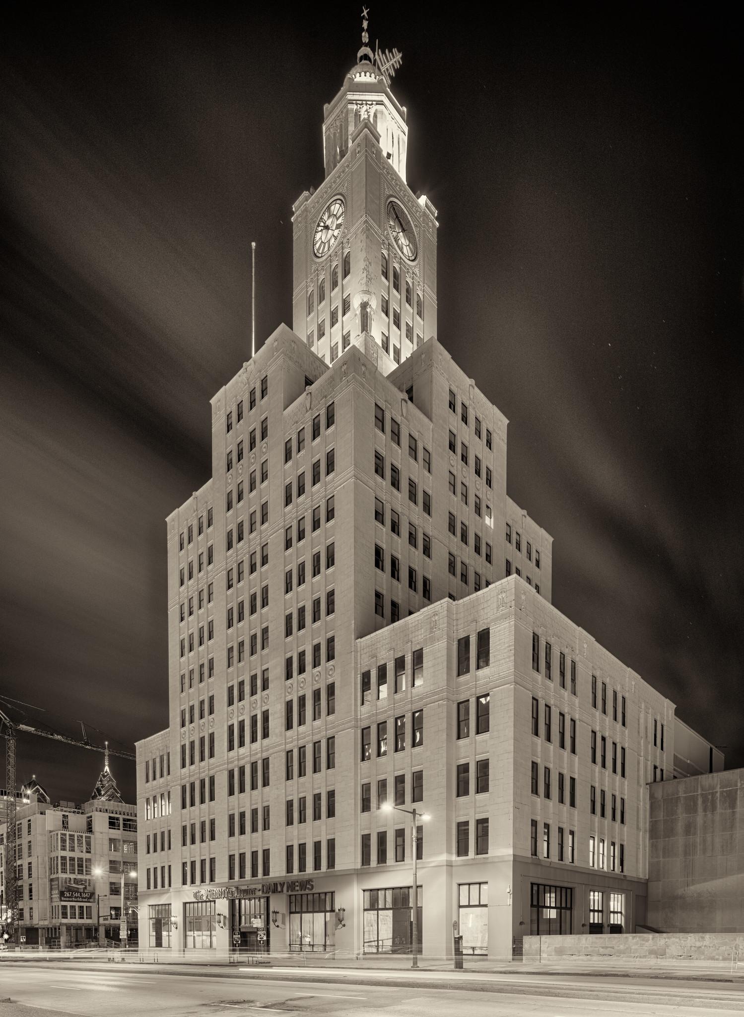 An early 20th century office building, with setbacks and a clock tower, at night. An early 20th century office building, with setbacks and a clock tower, at night.