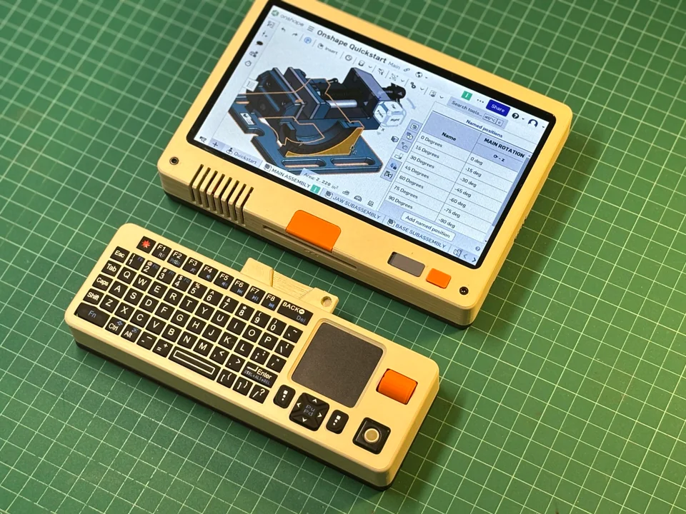 The piet, a cool retro-futuristic handheld console, showing FreeCAD on screen.