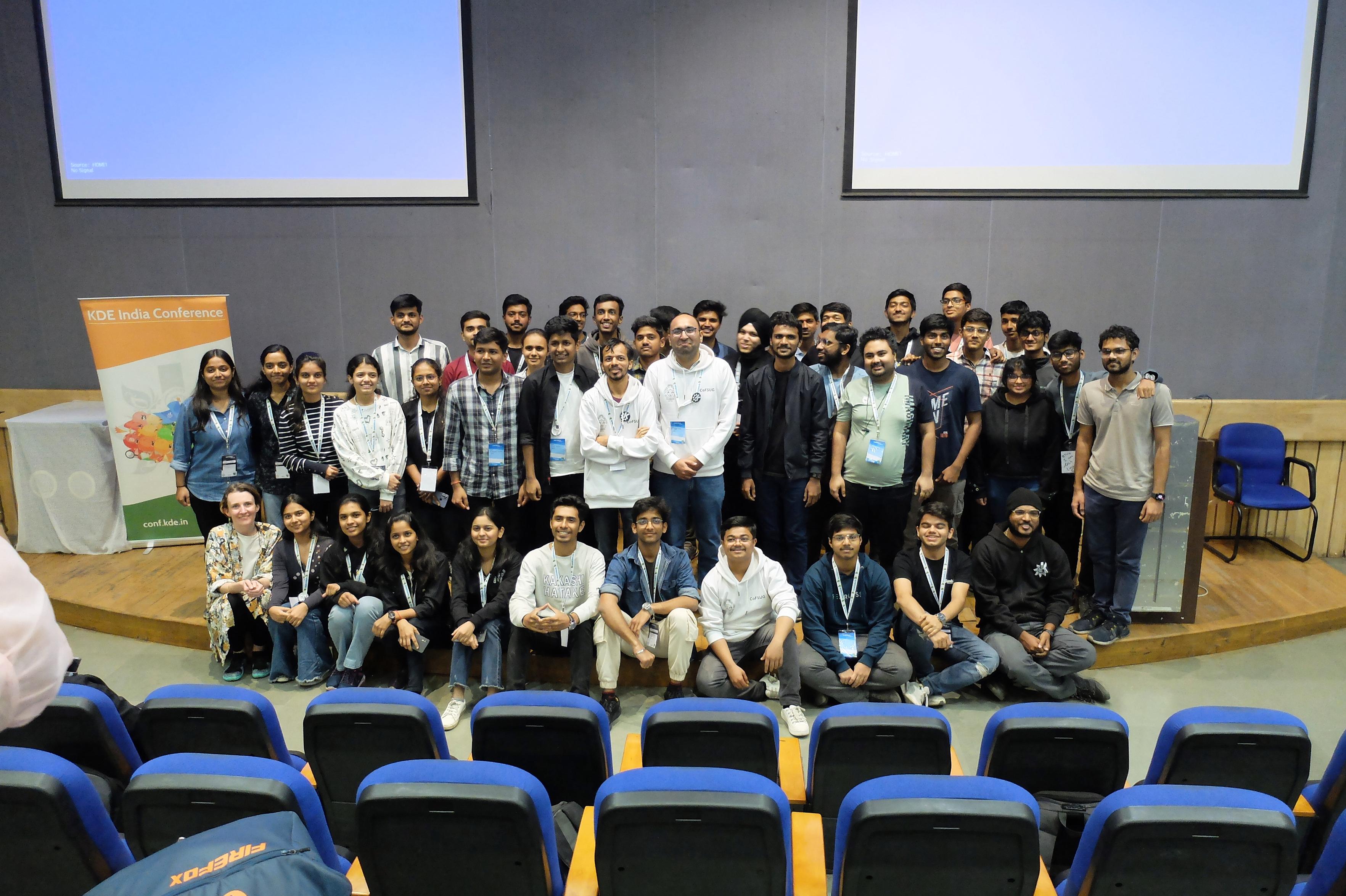 Attendees to the 2024 edition for conf.kde.in pose in a conference hall.