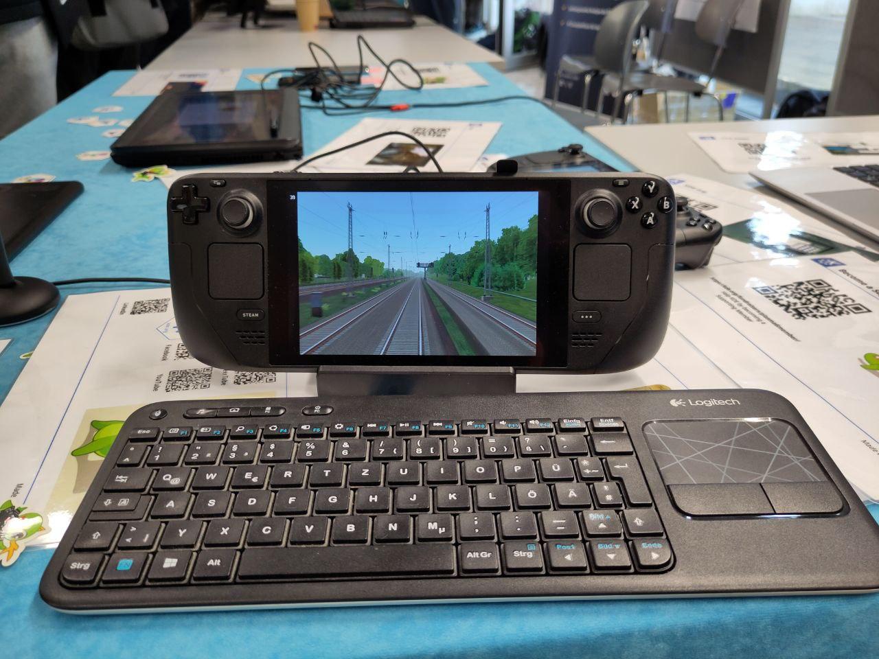 A handheld gaming console with a train simulator software running