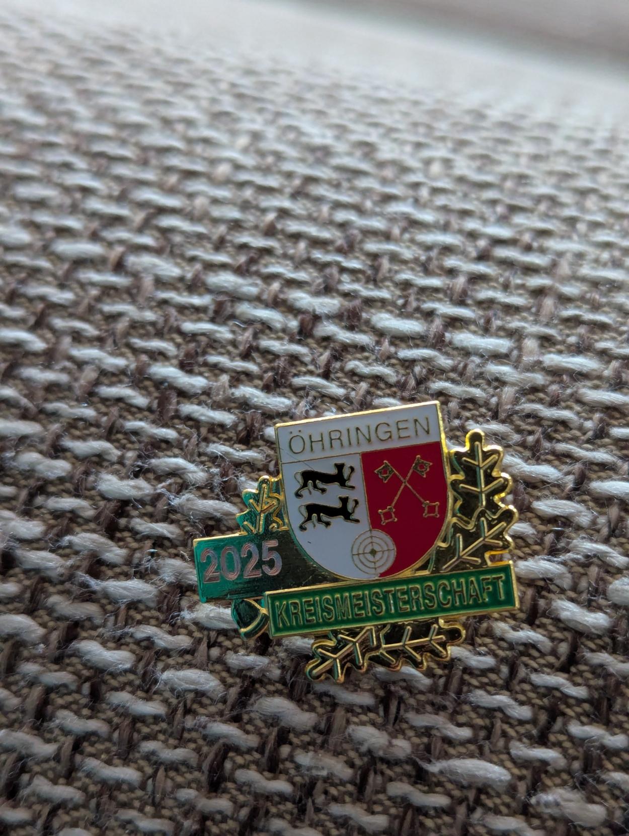 A golden pin that shows the flag of the county Öhringen. It reads "2025 Kreismeisterschaft“.