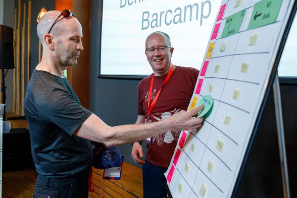 Barcamp attendee posting topic ideas on a clip chart
