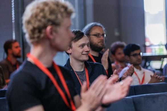 Attendees applauding and smiling
