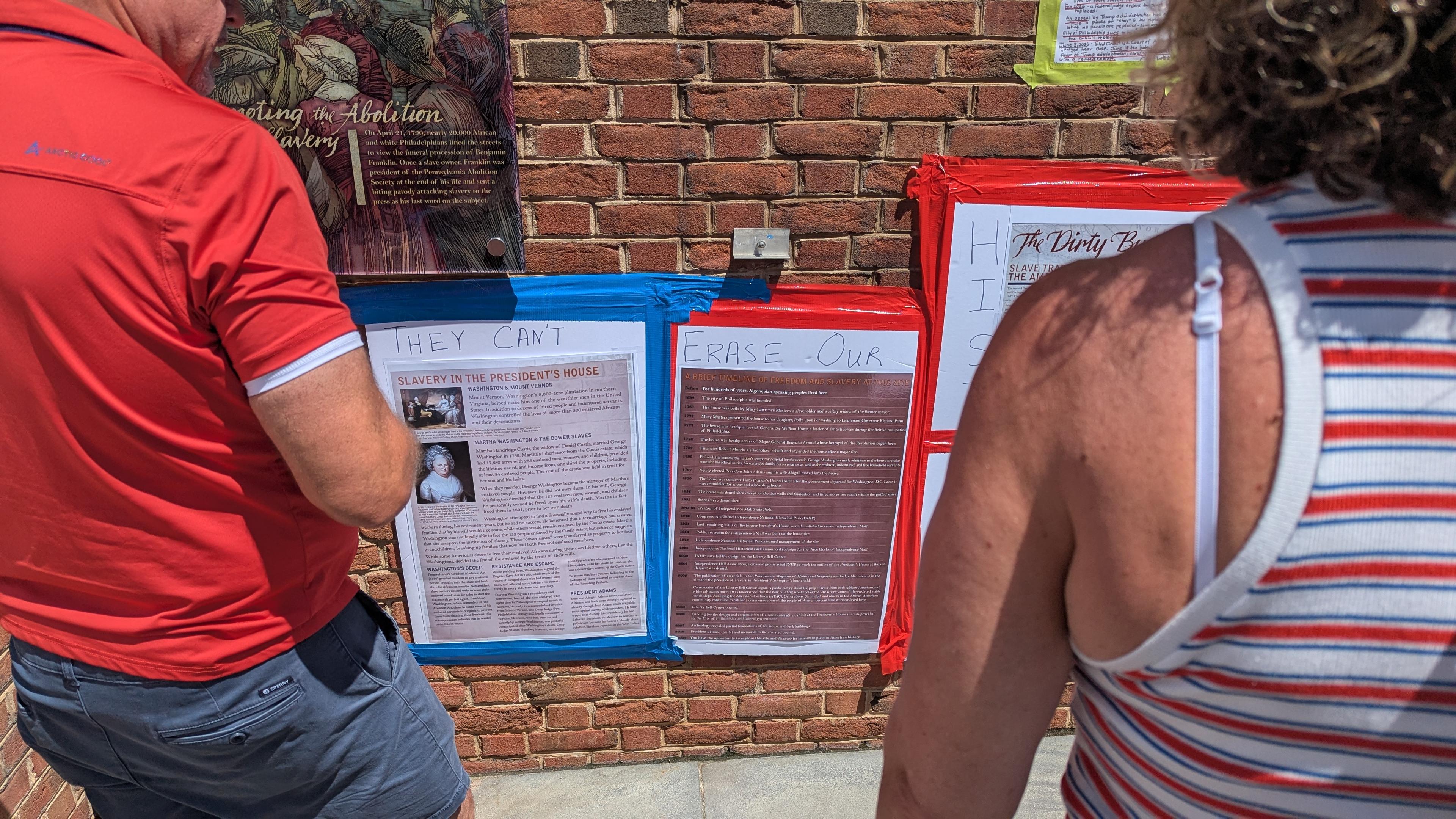 Photocopied copies of panels removed at the slavery exhibit and hand written "They can't erase our history"