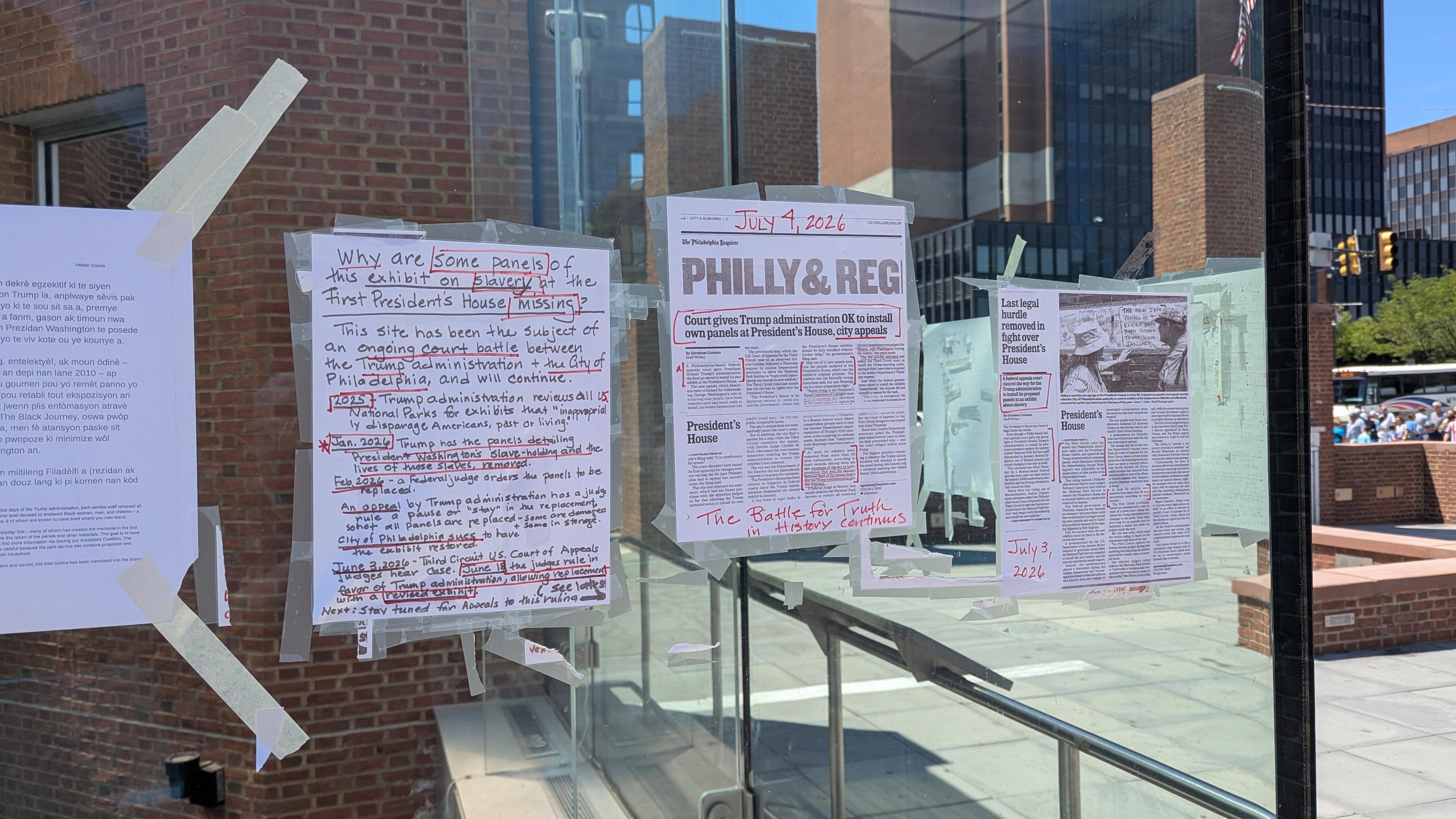 Taped explanation and hand-written signs about the removal of the slavery panels.