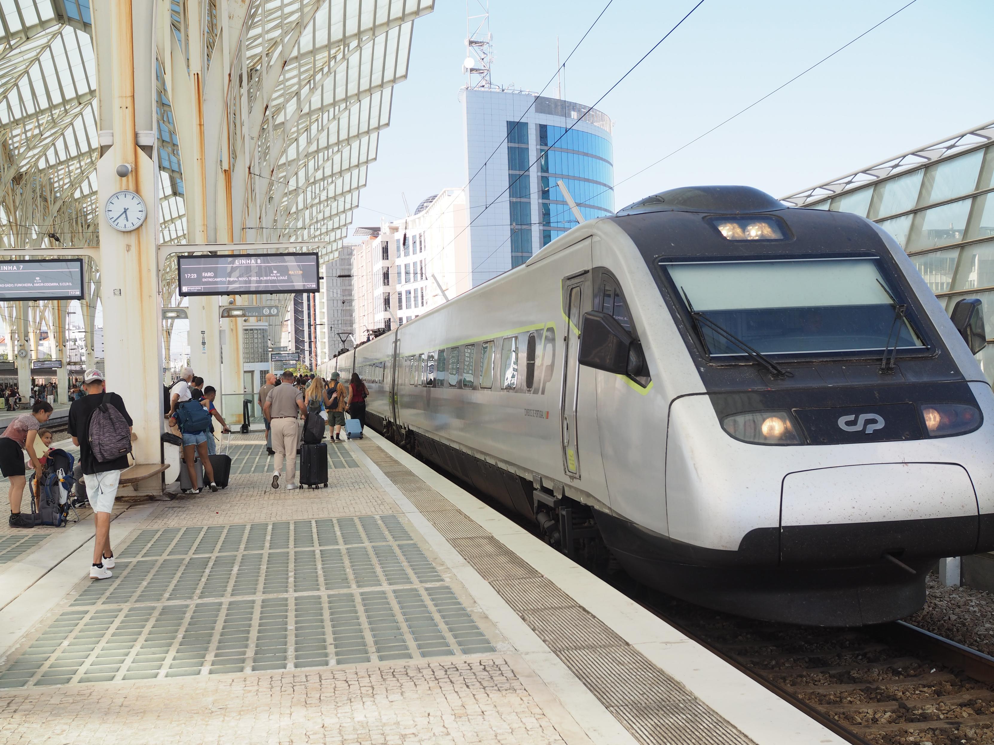 Track 8 of Lisboa Oriente with an intercity train waiting at the platform. The platform is white with white columns and a roof that looks organic like a white spider web or white palm trees.