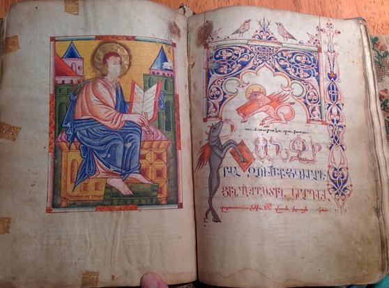 Illuminated bible with Armenian script.

On the left is a full page illumination of a figure with a book. On the right page there is an illuminated page with Armenian script.