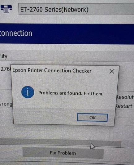 Unattributed screenshot, of a computer in the middle of a printer setup process. A popup labelled 'Epson Printer Connection Checker' covers most of the screen, with the helpful message "Problems are found. Fix them."
