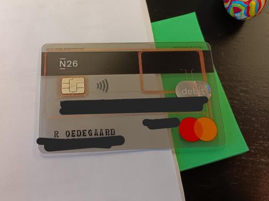 A transparent MasterCard. The account details of which have been blacked out. 

Through the clear plastic it is possible to see the thin copper wires that form the NFC aerial.
