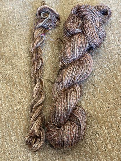 3 ply yarn. Large skein is the 3 bobbins plied together. Small skein is the leftovers chain plied once one bobbin ran out