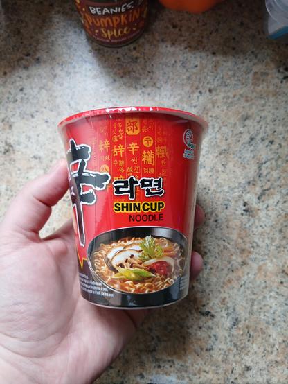 Side of a noodle cup. The brand is Shin Cup Noodle.