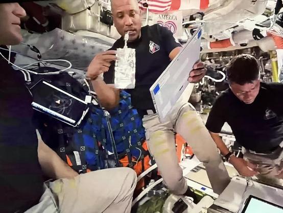 A screenshot of video inside the Artemis II spacecraft. They’re using Microsoft Surface Pro tablets, one is resting somewhere and it has a VLC media player screen on it with the orange traffic cone