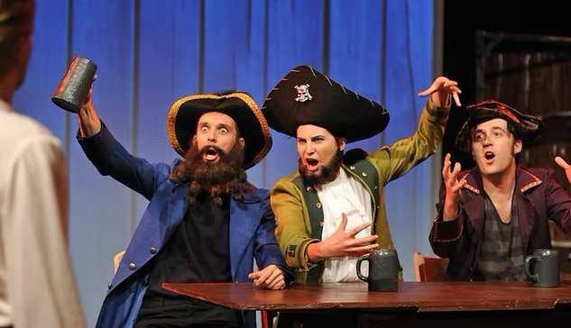 Three actors dressed as the Three Pirate Leaders from The Secret of Monkey Island video game as part of a stage performance.