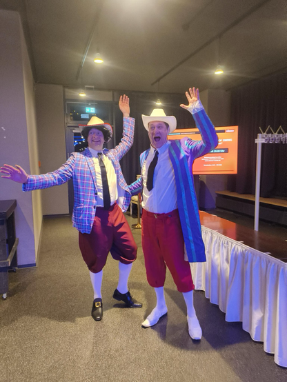 2 stans from monkey island pose for a photo