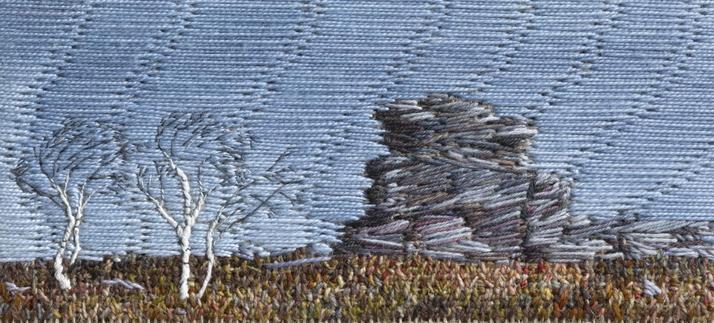 Stitched artwork depicting a gritstone outcrop in autumnal coloured moorland with two bare silver birch trees to the left. The trees are bent due to the prevailing wind. The sky is blue.