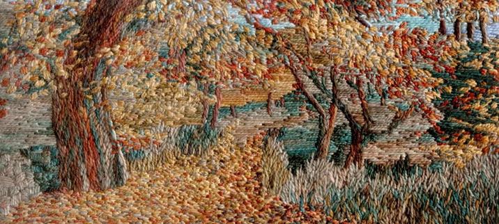 Stitched artwork depicting an autumn woodland with path leading away