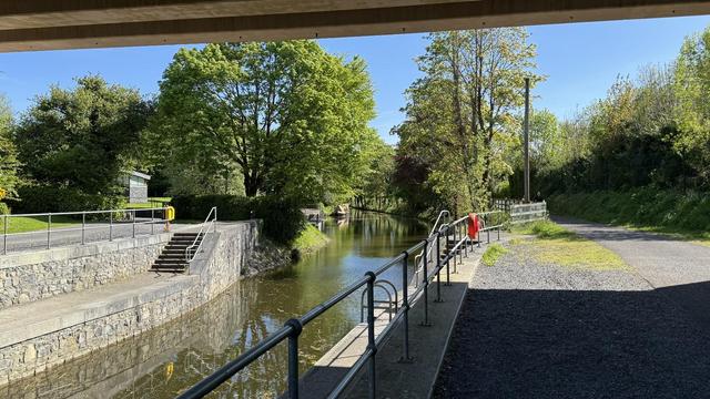 Photo, landscape, exterior: A canal harbour, seen from under a bridge. Lots of trees beyond.