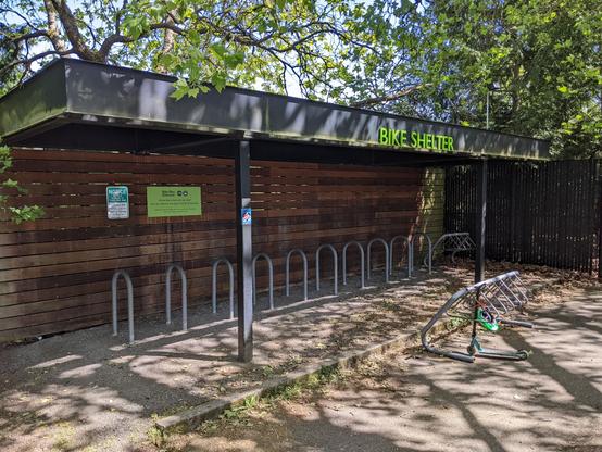The covered bicycle shelter and racks at the Woodland Park Zoo. It is a warm sunny afternoon in May, but Wednesday afternoon may be less of a bicycle travel day.