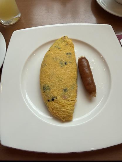 A small omelet and a plump sausage