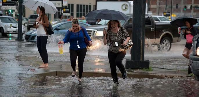 People running in a flooding street
