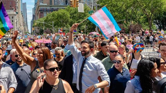 Zohran Mamdani marching at pride waving a trans flag over his head like the based BAMF he is.