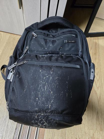 Photo of backpack with mud from bike tyre sprayed over it