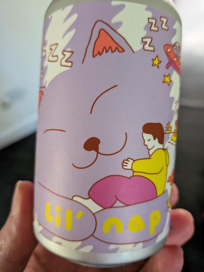 Can with a big purple cat taking a nap and text below "lil' nap"