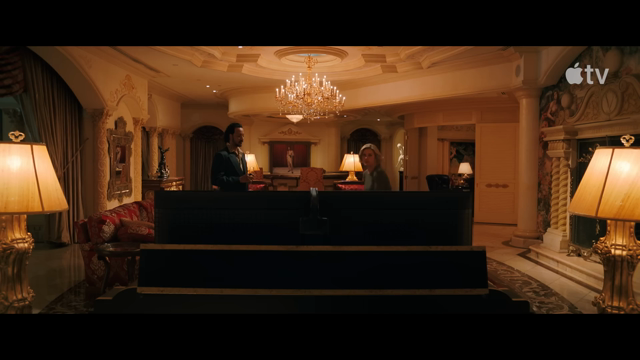 a person walks behind a TV in an ornate room. She says, "mkay... what do you got? H... uh, HDMI. Alright."