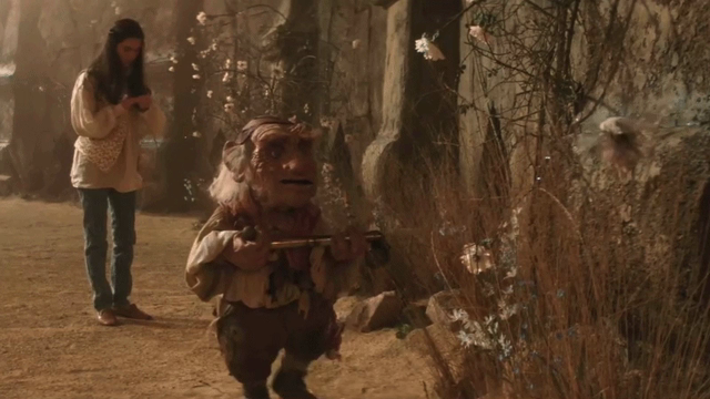 GIF of Hoggle from Labyrinth spraying a faerie with pesticide while Sarah stands in the background