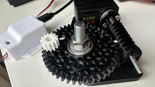 Black 3D printed worm and helix gears with white dots drawn on them to see the rotation.