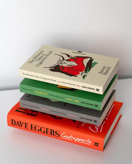 A pile of the books, The Minotaur Takes a Cigarette Break on top, a plain background