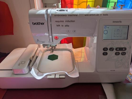 picture of patch being embroidered with embroidery machine, showing full machine