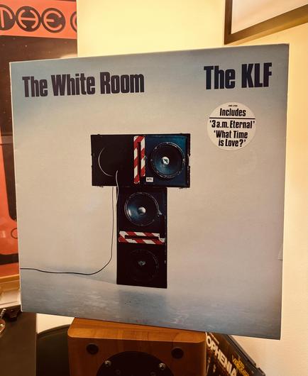 An LP cover features a speaker setup on a light background with text indicating "The White Room" and "The KLF" along with smaller info and song titles.