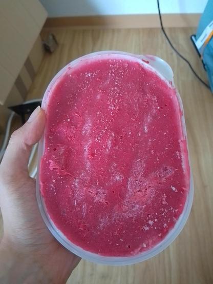 Ich halte eine 1L Packung mit einem gefrorenen roten Sorbet