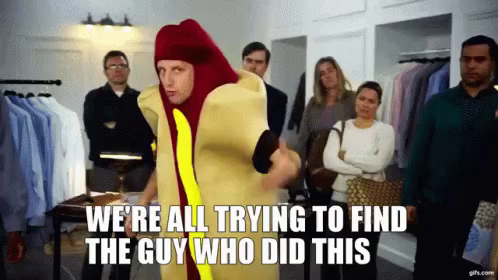 Hot Dog Man GIF "We're all trying to find the guy who did this" as the hot dog man gesticulates around