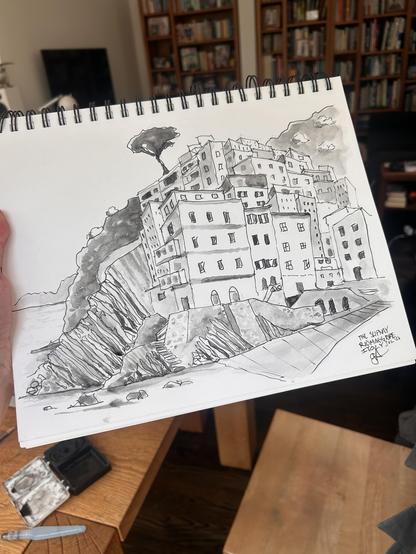 Monochrome sketch of a jumble of houses perched on a rocky cliff over the sea