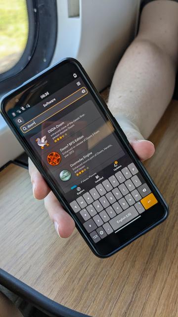 mobile phone with screen offering to install doom
