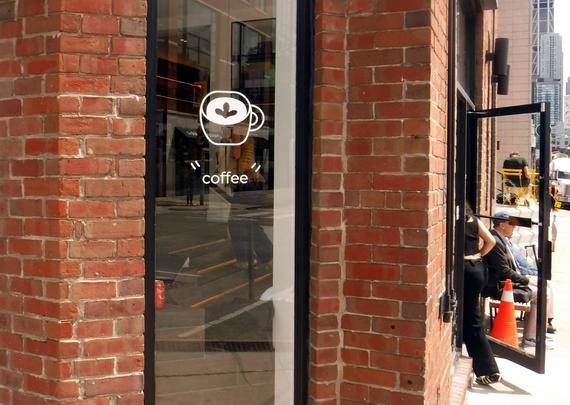 coffee shop on southeast corner of Yonge St and Rowanwood Ave advertises itself with a drawing of a cup and the word "coffee" in quotes