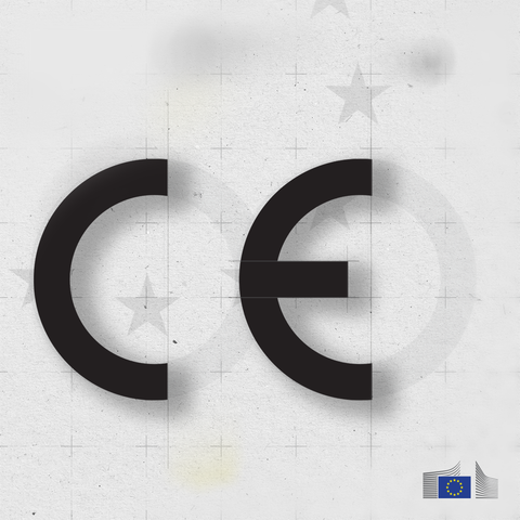 The image shows a black CE marking in a shadow effect giving it a three-dimensional appearance on a textured light gray background with EU stars. In the bottom right corner, there is a logo of the European Commission.