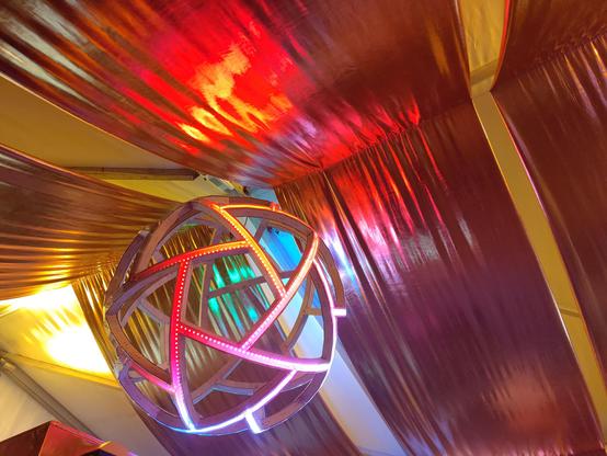 my LED sphere hanging at the cybar; draped golden fabric in the background