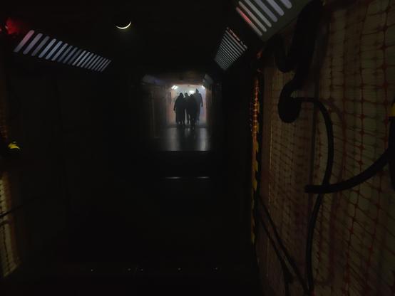the null sector tunnel to the dance floor; shadowy figures in the back
