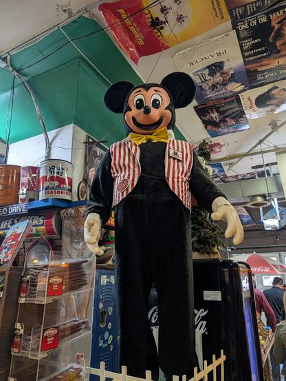 A not-quite-Mickey Mouse statue thing covered in fur and wearing a striped vest. It is the size of a man. It is terrifying.