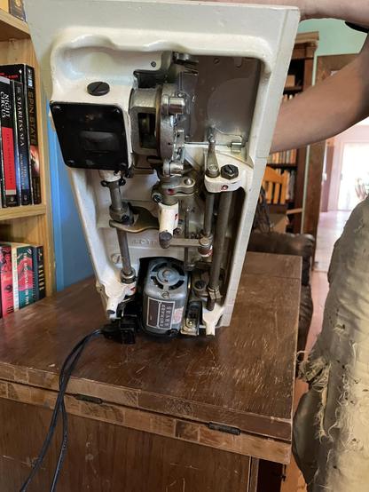 The bottom of the sewing machine, which is tilted up.