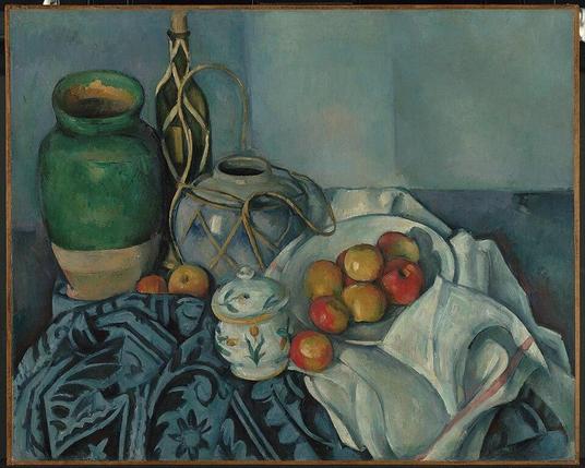 Still Life with Apples by Paul Cézanne.

A green ceramic jar, a wine bottle wrapped in wicker, a wicker-wrapped jug, a small floral-patterned sugar bowl, and a bowl of red and yellow apples, all arranged on a table draped with a patterned blue cloth and white fabric.