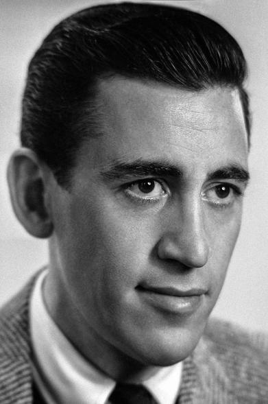 Portrait of American author J. D. Salinger photographed by Lotte at Atelier Jacobi in New York City, October 11, 1950 (source: Fine Books & Collections). The photo was used as an author portrait on the first-edition dust jacket of Salinger's 1951 novel The Catcher in the Rye. It was removed from subsequent editions of the novel at the author's request.

This is a black-and-white photograph of J.D. Salinger, shown with dark slicked-back hair, wearing a tweed jacket, white collared shirt, and tie, with a slight, subtle smile.