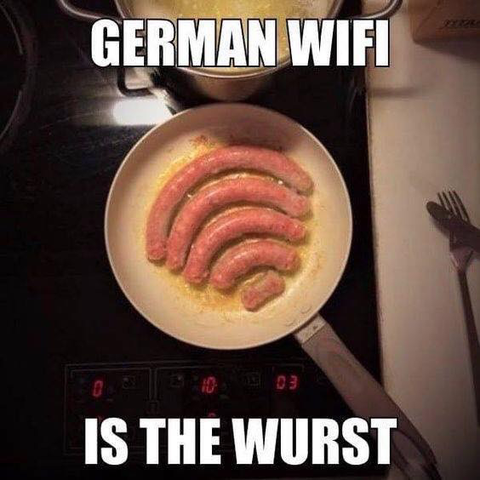 A meme showing five curved sausages of decreasing size frying in a pan, arranged like Wi-Fi signal bars. Bold text reads: “GERMAN WIFI IS THE WURST,” a pun on German sausage (“wurst”) and bad Wi-Fi.